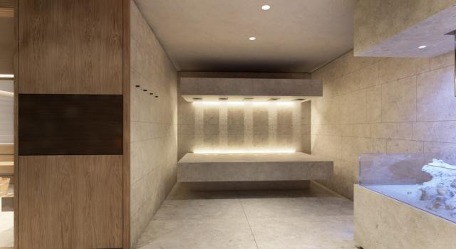 Elegante bagno turco con illuminazione soffusa e pareti in pietra.